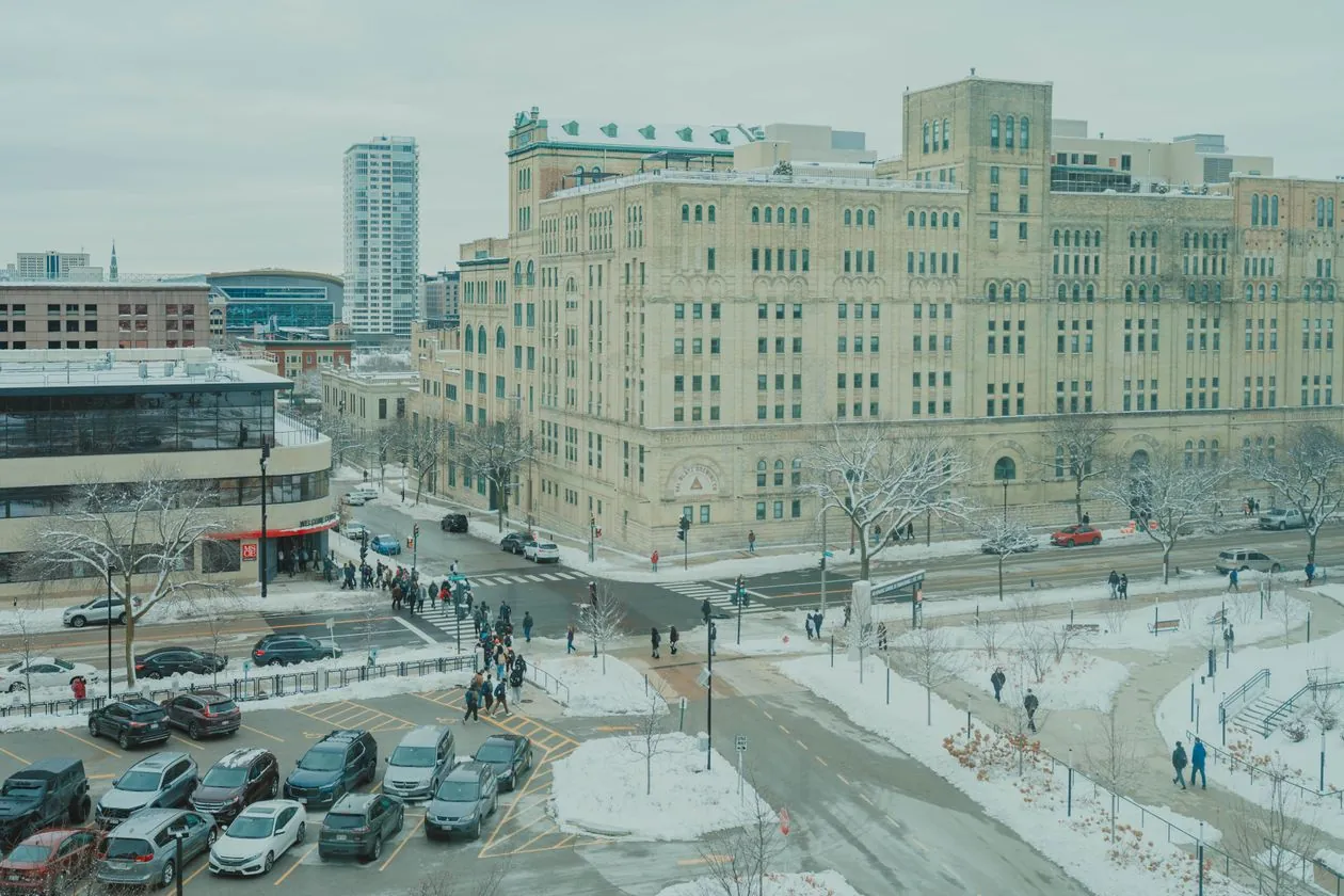 Snowy downtown Milwaukee city street with historic buildings on an overcast winter day